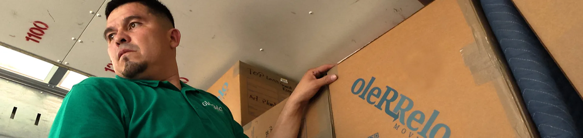Oler Relo Moving Crew Loading the Truck | Local Moving Quote An Oler Relo Moving crew member checking labeled boxes inside a moving truck during a local move