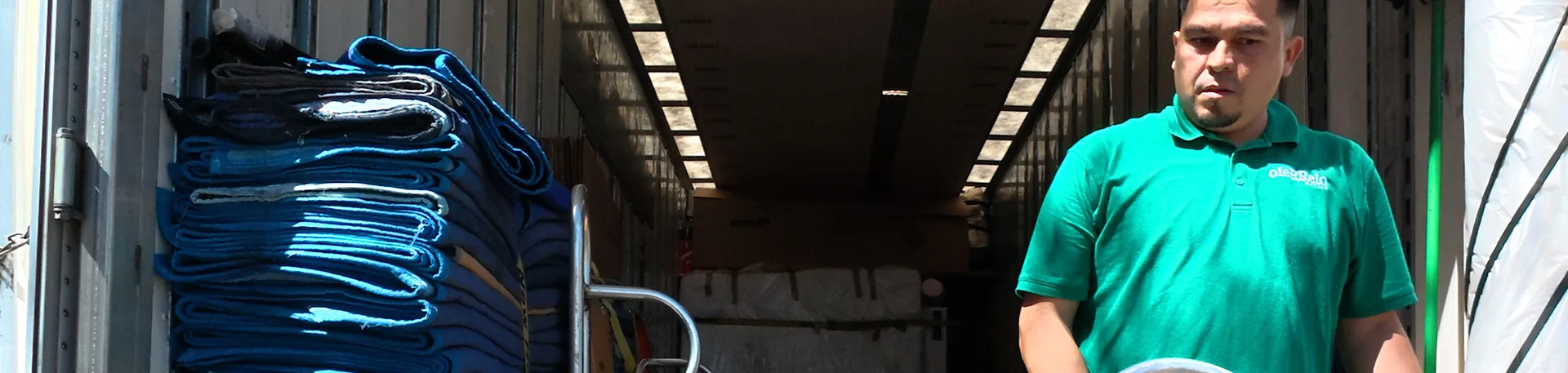 Mayflower Transit Network in Action | Oler Relo Moving Oler Relo Moving crew loading moving blankets into a Mayflower trailer for an interstate move