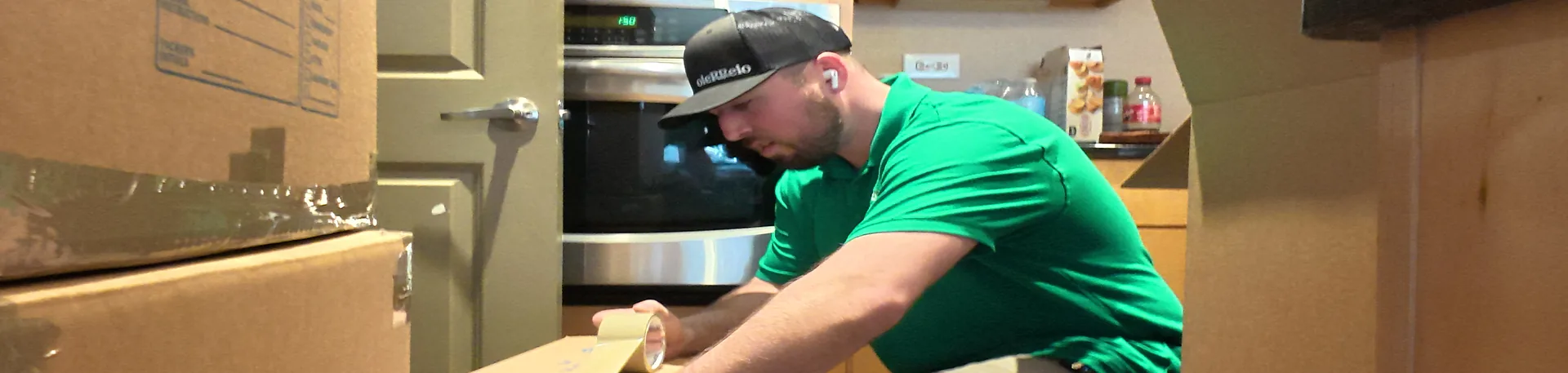 Careful Packing for Interstate Moves | Oler Relo Moving An Oler Relo Moving crew member taping a moving box shut during an interstate move