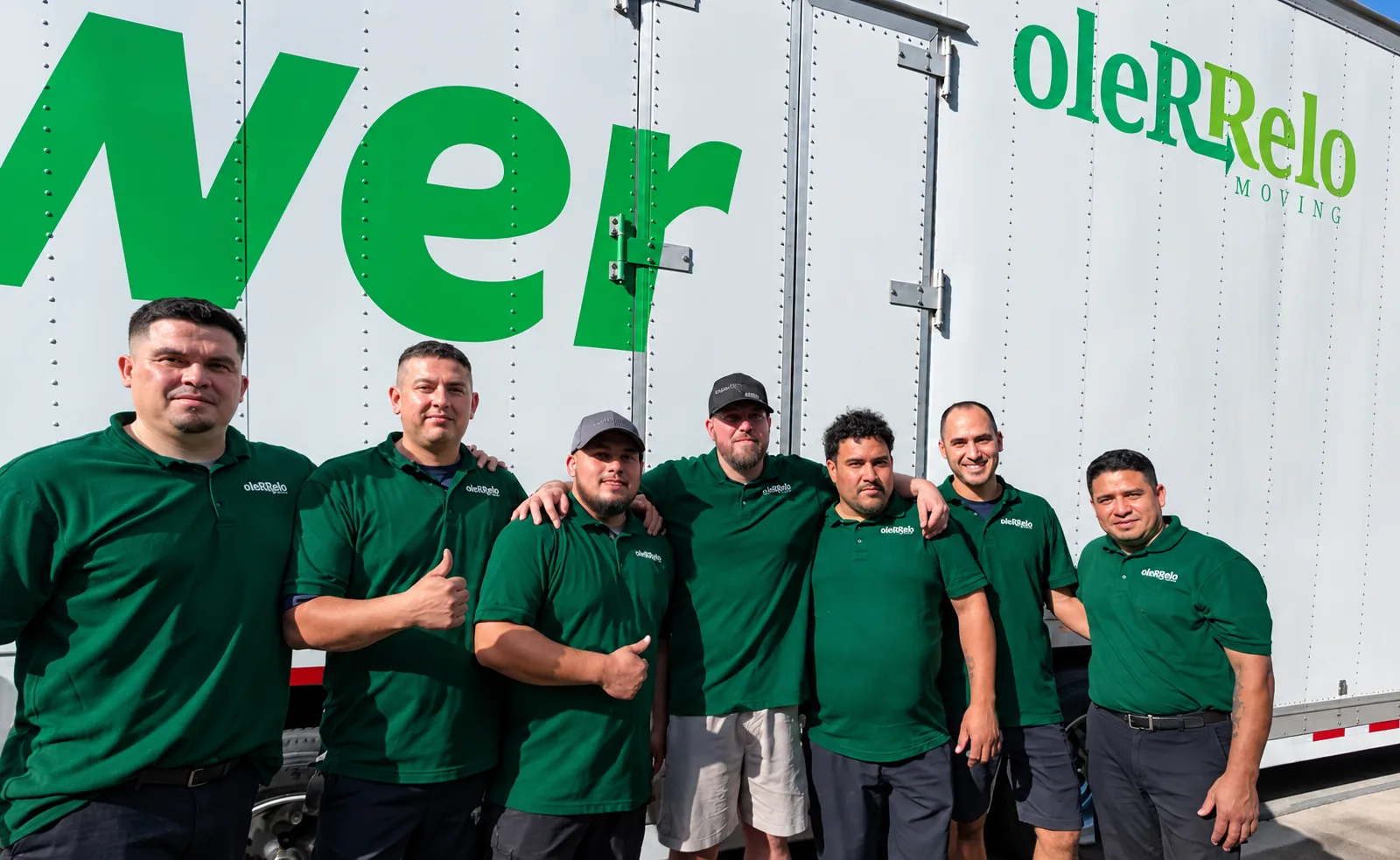 Our Moving Crew and Mayflower Truck | Oler Relo Moving The Oler Relo Moving crew in green polo shirts in front of a Mayflower moving truck