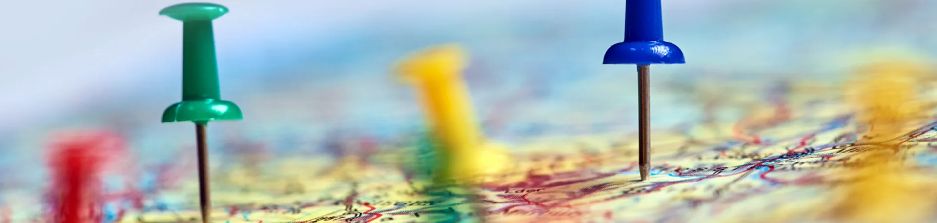 Nationwide Commercial Moving Network | Oler Relo Moving Green, yellow, blue and red push pins marking destinations on a road map
